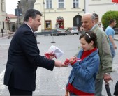Burmistrz Miasta Andrzej Wyczawski rozdaje flagi mieszkańcom miasta